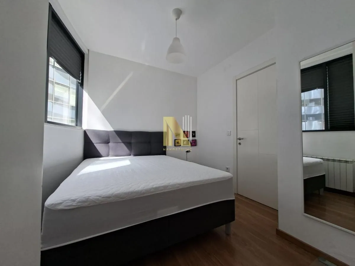 Bedroom with a double bed, window and door.