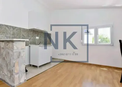 Small kitchen with white cabinets and a stone-clad breakfast bar. - image 3