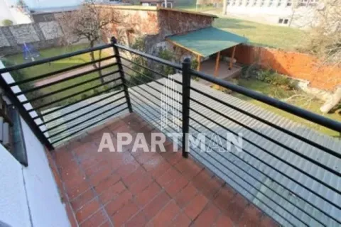 Balcony with a metal railing and a view of the courtyard. - image 8