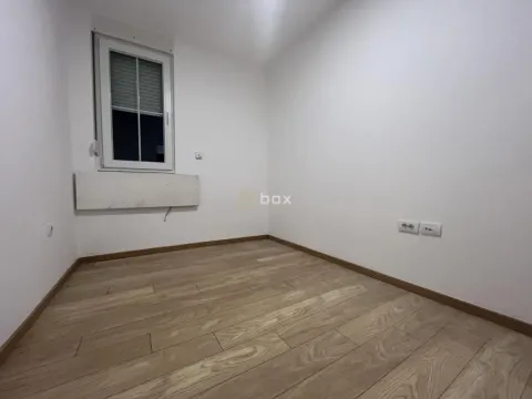 Empty room with white walls, wooden flooring and a window. - image 6