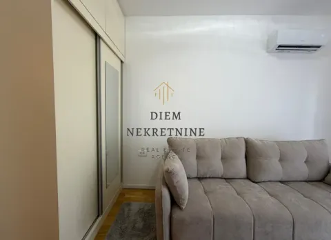 Living room with a beige sofa and built-in wardrobe. - image 12