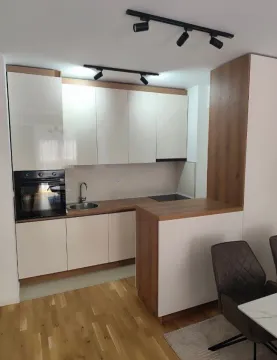 Moderna kuhinja sa bijelim elementima i drvenim detaljima. - image 4