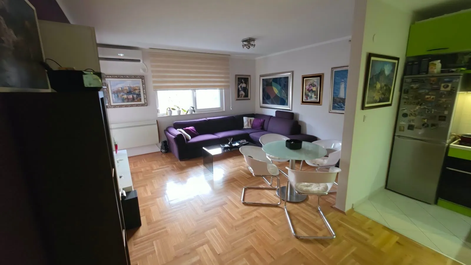Spacious living room connected to the dining area with a view of the seating set.