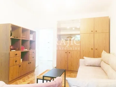 Living room with a sofa and wooden wardrobes. - image 4