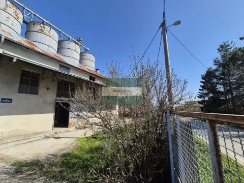 View of the exterior of an industrial building with silos and a courtyard. - image 2