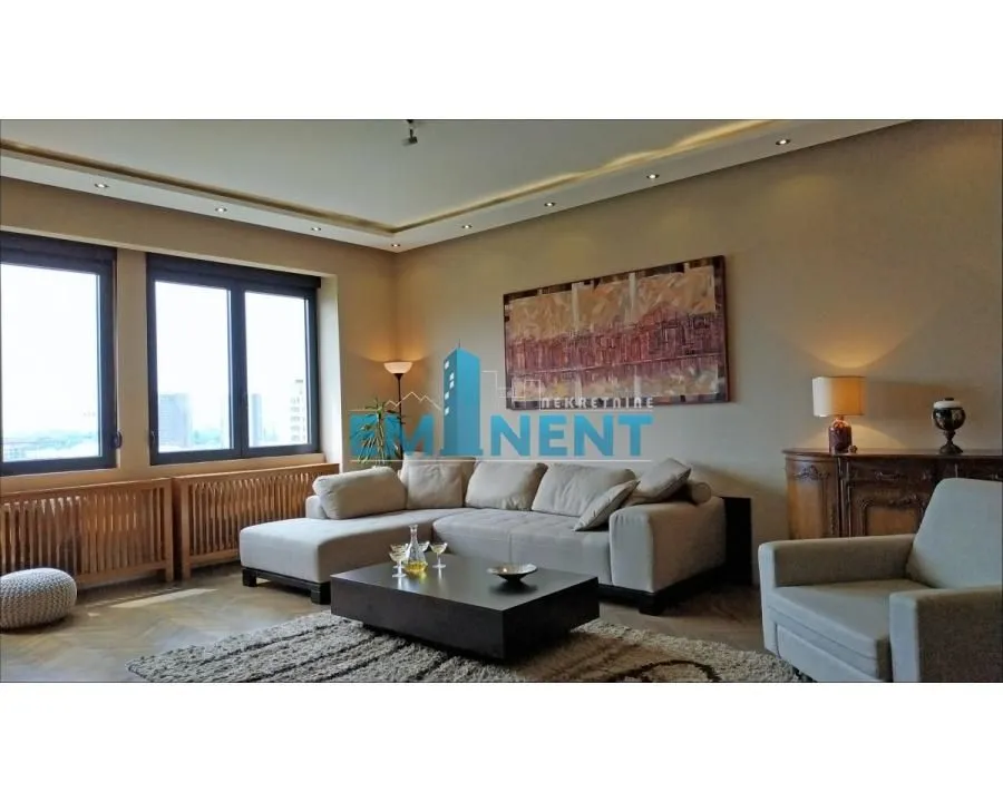 Spacious living room with a sofa set and large windows.