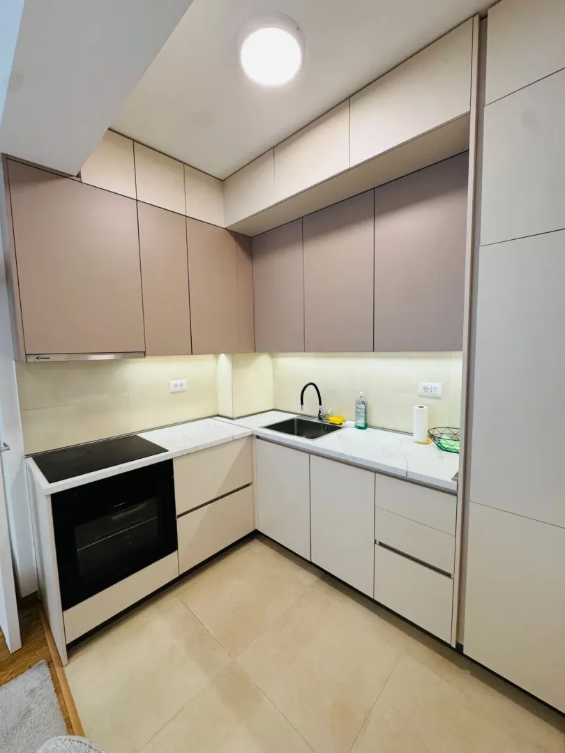 Modern kitchen with built-in cabinetry and white countertops.