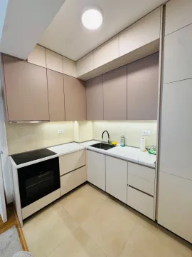 Modern kitchen with built-in cabinetry and white countertops. - image 3
