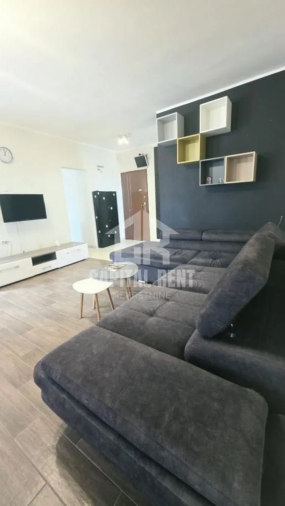 Living room with a large sectional sofa and television.
