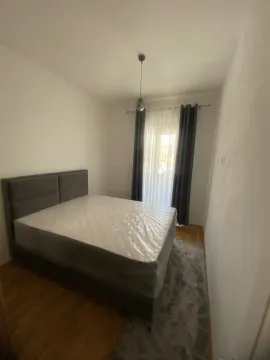 Furnished bedroom with a double bed and a window. - image 4