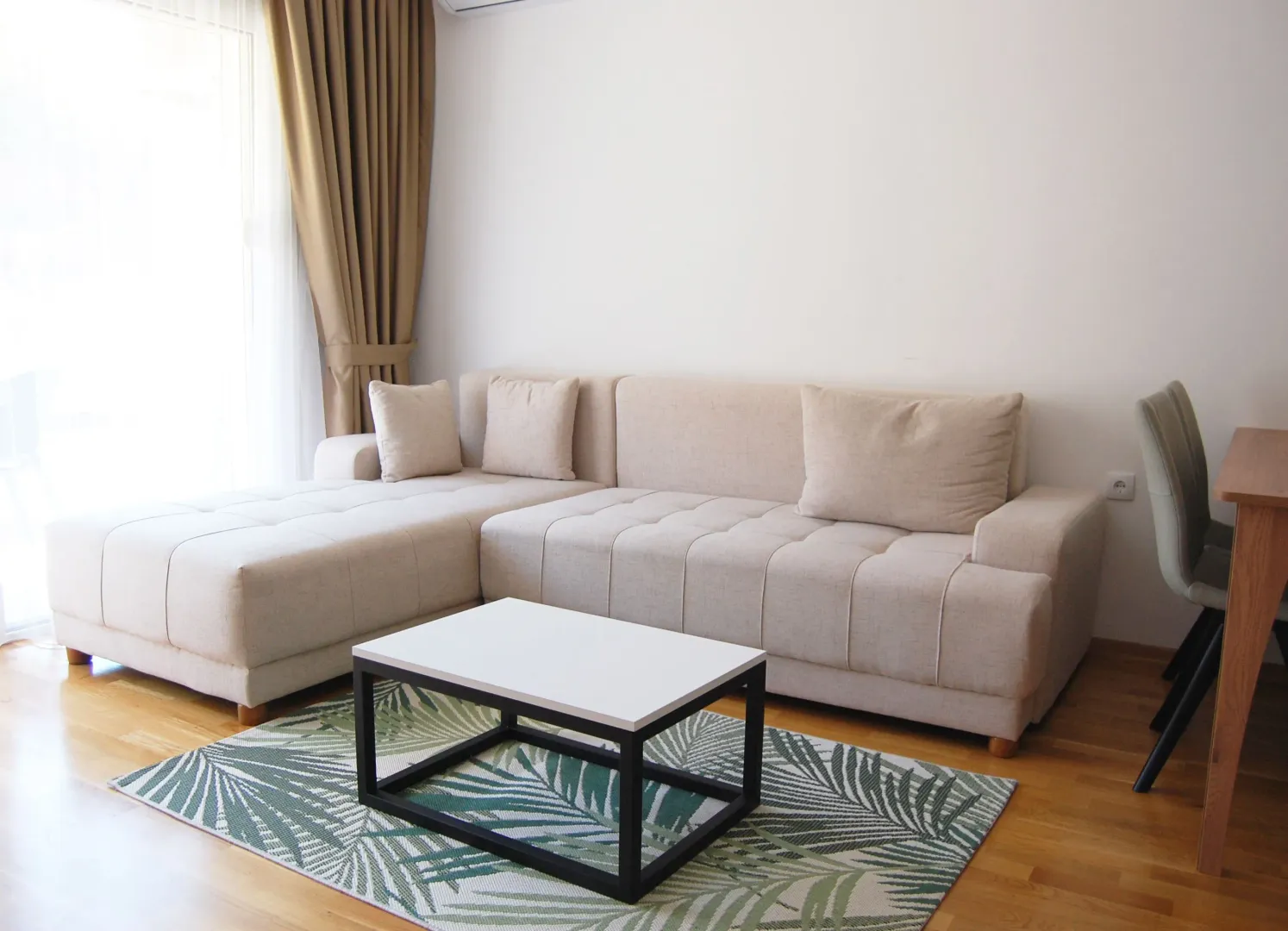 Bright and tidy living room with a corner sofa and a coffee table.