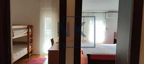 View from the hallway into bedrooms with beds. - image 9
