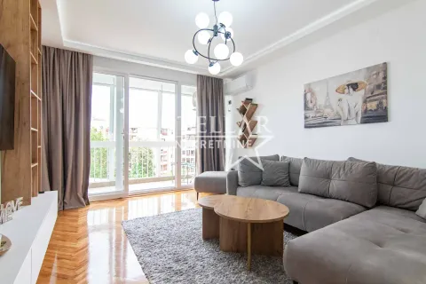 Living room with a sectional sofa, wooden coffee table, and access to the terrace. - image 3