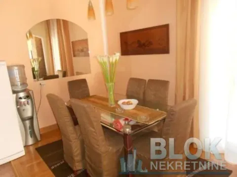 Dining area with a table, chairs, and a wall mirror. - image 4