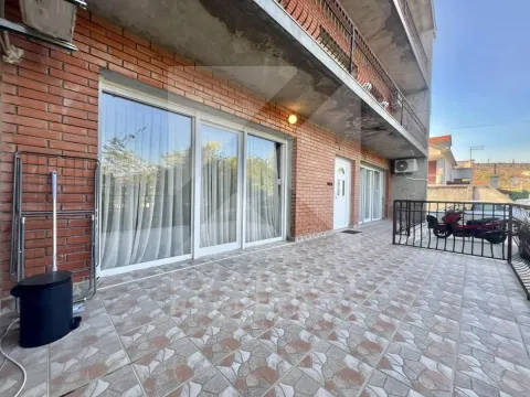 Spacious tiled terrace in front of the ground floor entrance of a house with a brick facade. - image 8