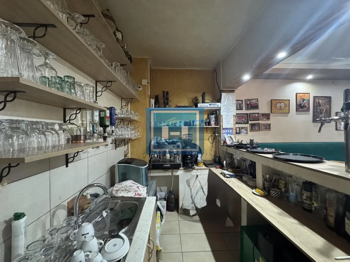 Commercial kitchen with glassware shelves and a bar counter.