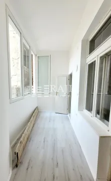 Long bright enclosed terrace with glass windows and laminate flooring. - image 5