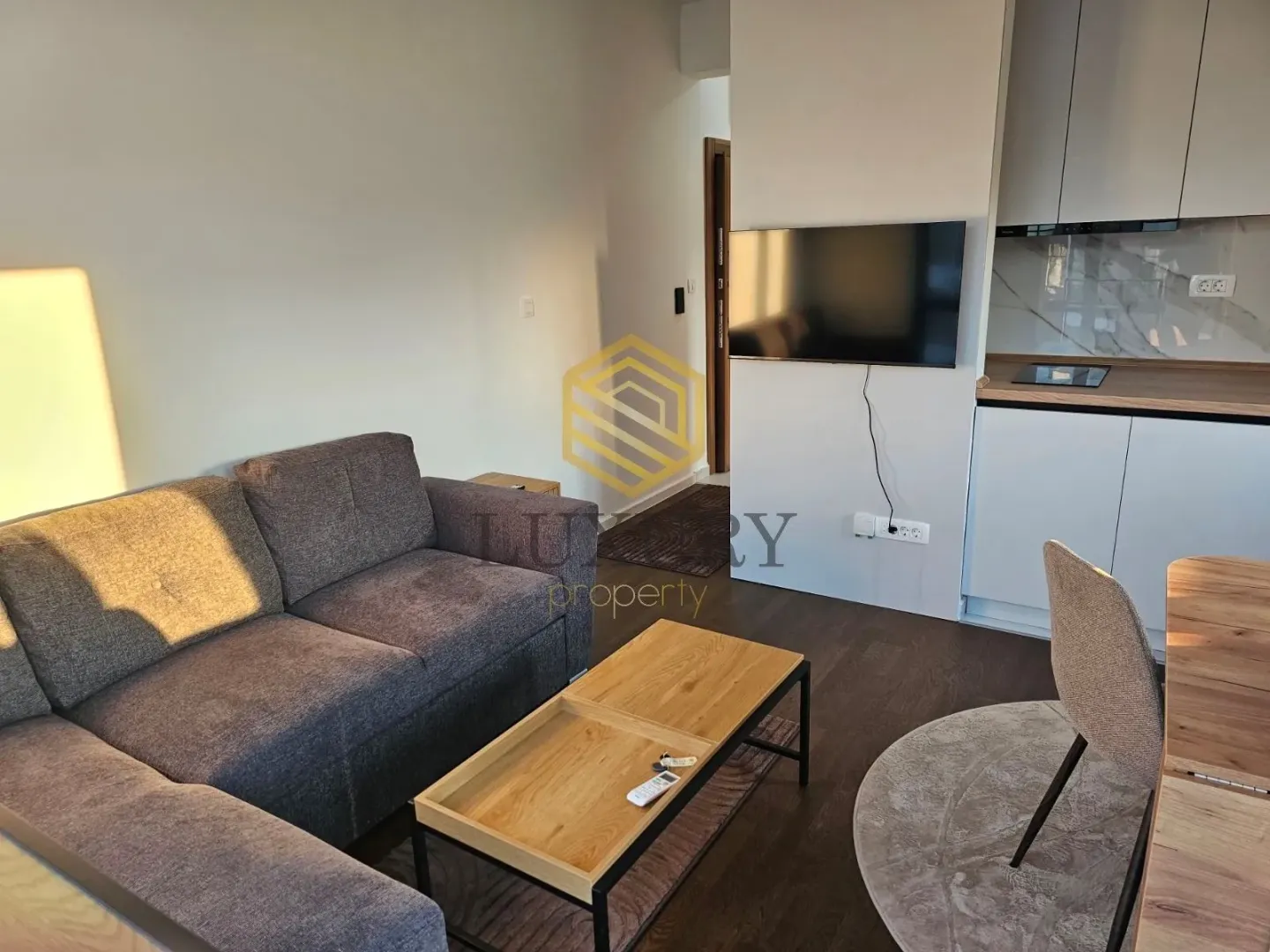 Living room with a sofa connected to the kitchen.