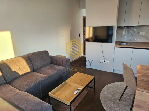 Living room with a sofa connected to the kitchen. - image 2