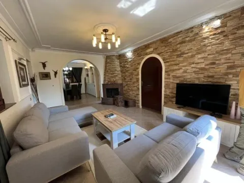 Bright living room featuring comfortable sofas and a decorative stone wall. - image 8