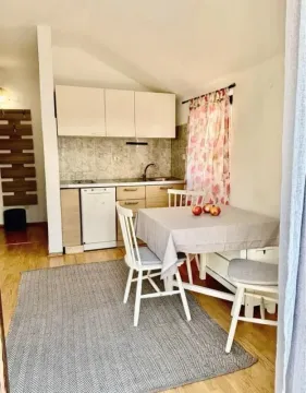 Small kitchen with a dining table and chairs. - image 5