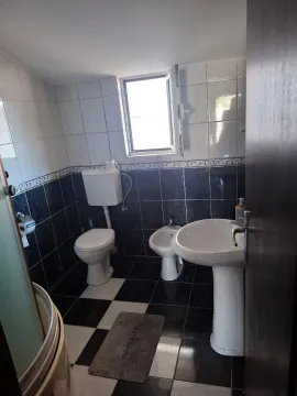 Compact bathroom with white and dark tiles, sink, toilet, and bidet. - image 3