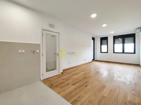 Empty living room with wooden flooring and windows. - image 8