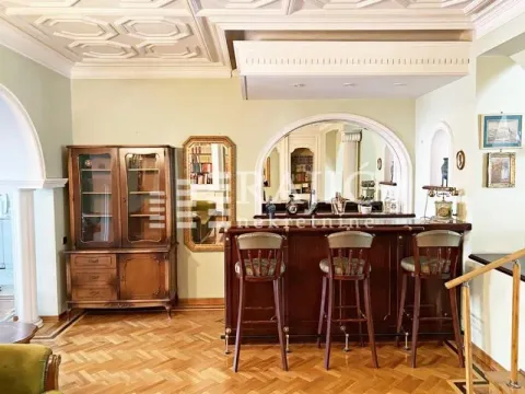 Living room with a bar counter and wooden furniture. - image 3