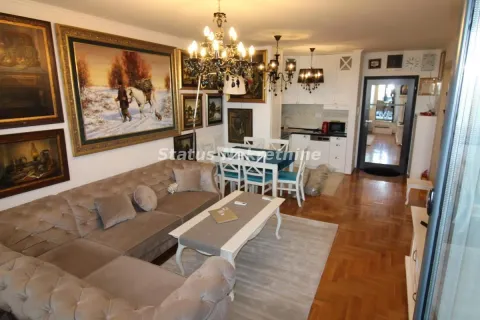 Living room with sofa set, dining area, and artwork on the walls. - image 4