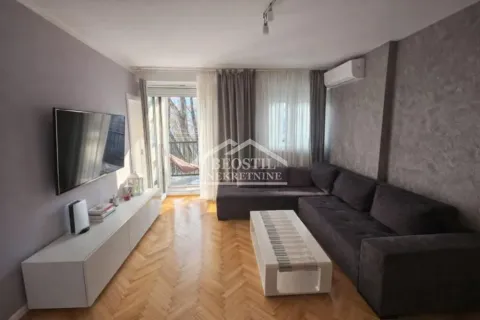 Living room with a sectional sofa, TV, and access to the balcony. - image 9