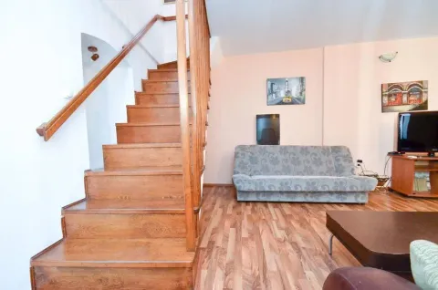 Living room featuring a wooden staircase and a sofa. - image 11