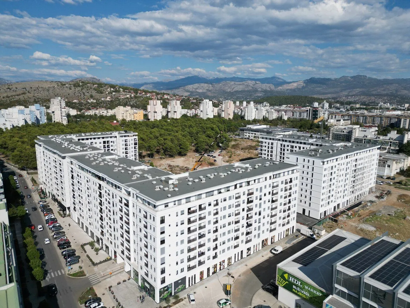 Aerial view of modern residential buildings and the surrounding neighborhood.
