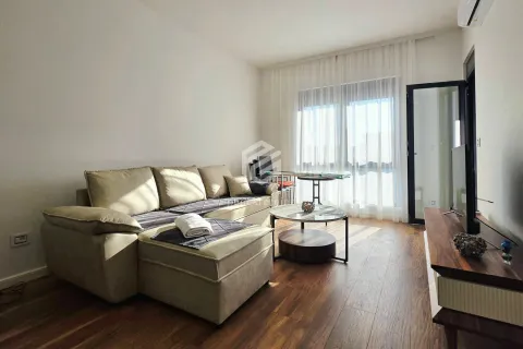 Living room with a sectional sofa, coffee table, and television. - image 11