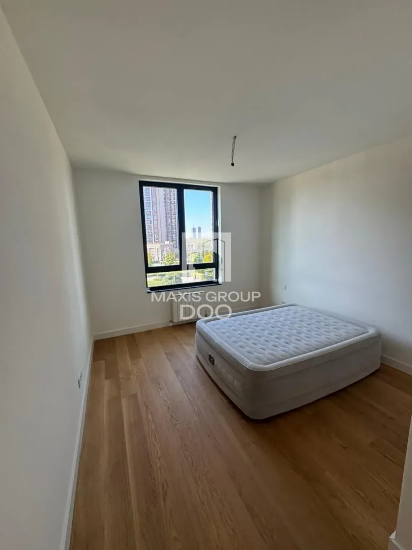 Empty room with a bed and a window.