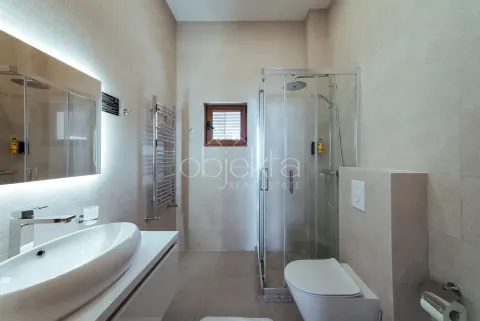 Modernly equipped bathroom with a shower cabin, washbasin, and toilet. - image 11