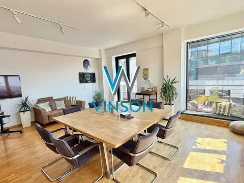 Spacious living room with a dining table and large windows. - image 2