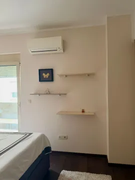 View of part of the bedroom with a bed, shelves, and air conditioning unit. - image 15