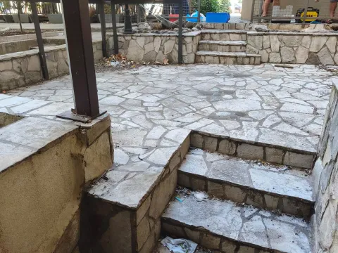 Stone-paved yard with stairs and retaining walls. - image 5