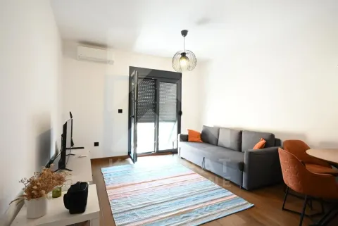 Living room with a sofa, dining table, and access to the terrace. - image 3