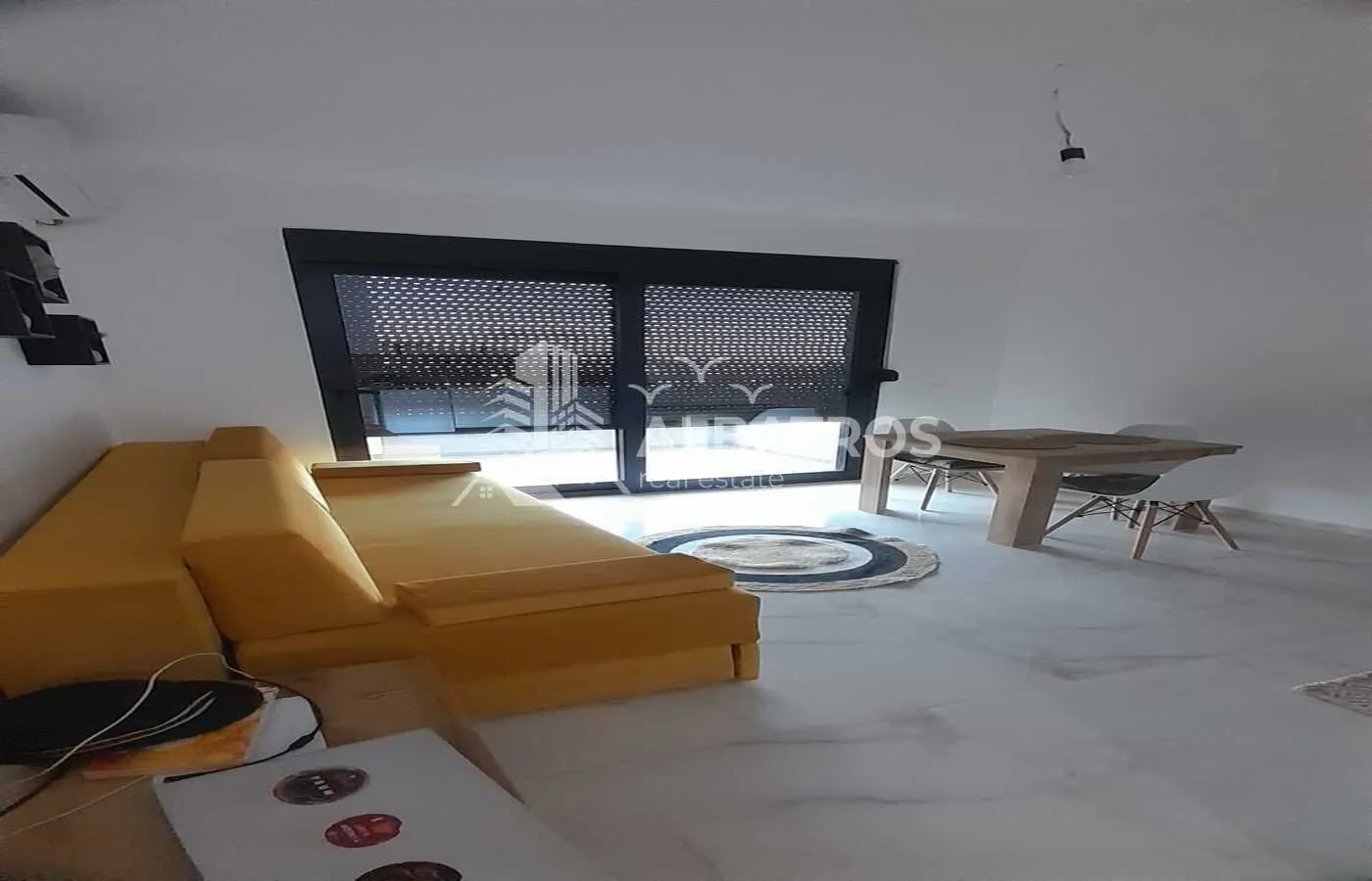 Living room with a sofa and dining table.