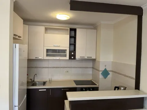 A kitchen with light upper and dark lower cabinets. - image 2