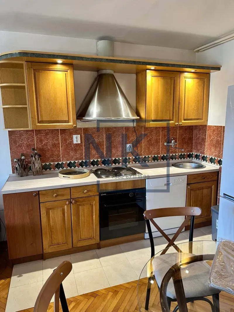 Traditional kitchen with wooden cabinetry and built-in appliances.
