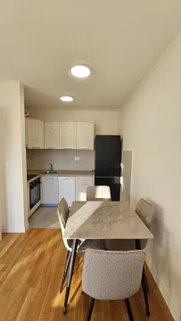 Small kitchen with a dining table and chairs. - image 3