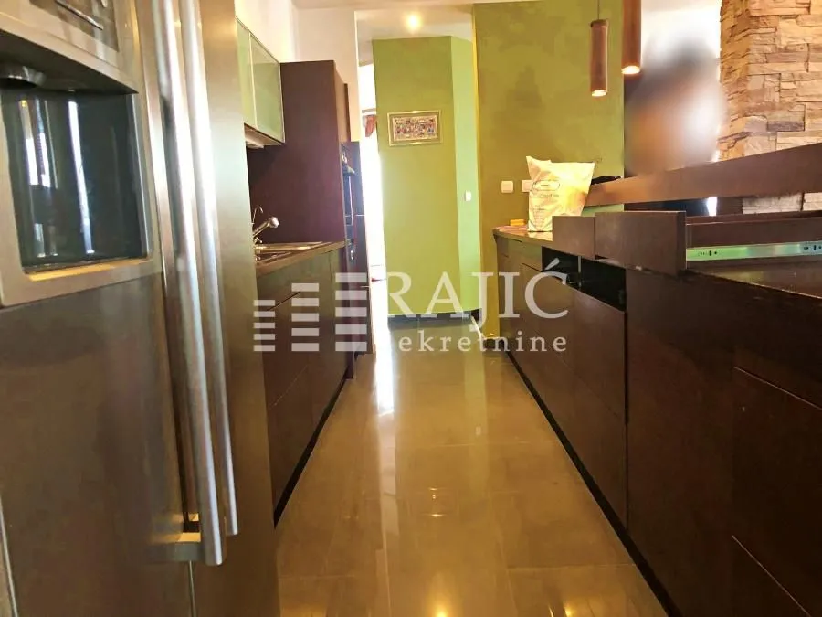 View of a modernly equipped kitchen with dark elements.