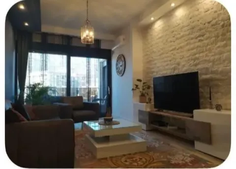 Living room with a sofa set, television, and coffee table. - image 3