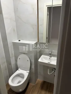 Small equipped bathroom with a toilet and sink. - image 8