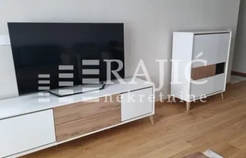 Living room with a TV unit and television. - image 2