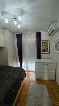 Furnished bedroom with a double bed, wardrobe, and chest of drawers. - image 11