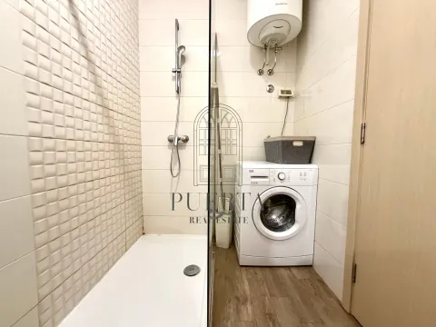 Modernly equipped bathroom with a shower cabin and washing machine. - image 11