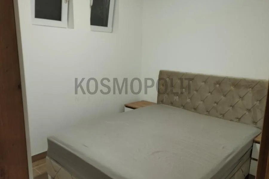Furnished bedroom with a double bed and nightstands.